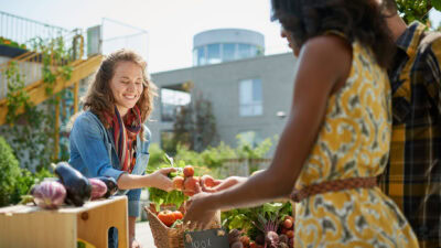 Community member selling produce at the local farmers market.